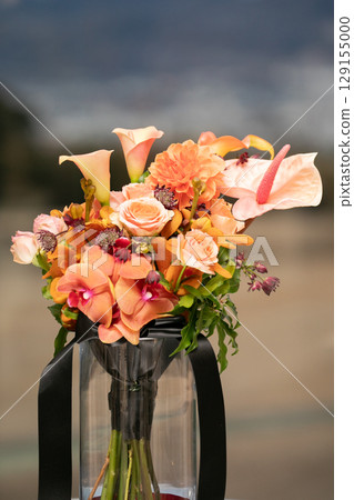 A gorgeous bouquet with vibrant warm colors for weddings 129155000
