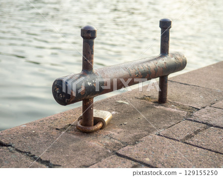 Small thin bollard. Bollard for boats. Parking for small vessels. Small city pier. 129155250