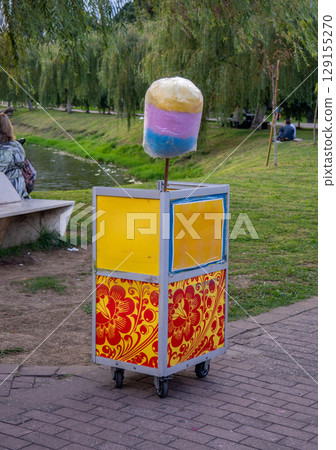 Mobile tray selling cotton candy. Local business. Sweets for children. 129155270