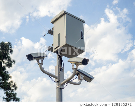 Street surveillance camera on a pole. Transformer panel. Against crime. Recording on a stationary camera. Fighting crime. Concept of issuing a fine. Traffic monitoring. 129155271