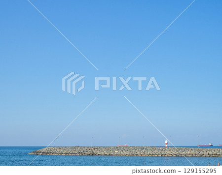 Sea coast against the backdrop of the city.  Rocky shore of the Black Sea. Seaside holiday concept 129155295