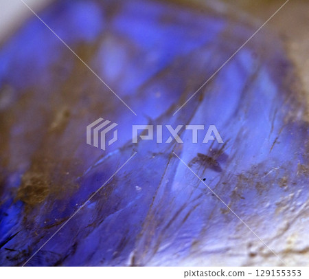 Beautiful close up of quartz crystal rock shard with reflective rainbow spiritual light 129155353