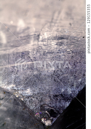 Beautiful close up of quartz crystal rock shard with reflective rainbow spiritual light 129155355
