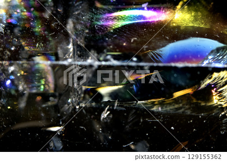 Beautiful close up of quartz crystal rock shard with reflective rainbow spiritual light 129155362