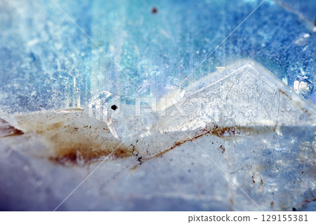 Beautiful close up of quartz crystal rock shard with reflective rainbow spiritual light 129155381