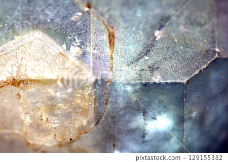 Beautiful close up of quartz crystal rock shard with reflective rainbow spiritual light 129155382