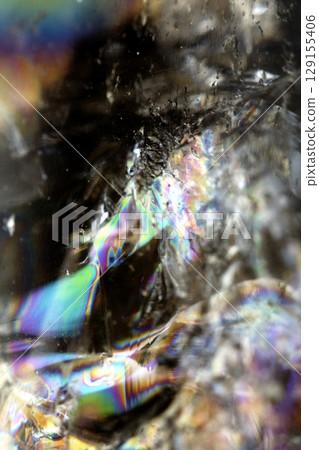 Beautiful close up of quartz crystal rock shard with reflective rainbow spiritual light Beautiful close up of quartz crystal rock shard with reflective rainbow spiritual light 129155406