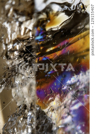 Beautiful close up of quartz crystal rock shard with reflective rainbow spiritual light 129155407