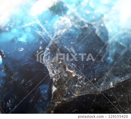 Beautiful close up of quartz crystal rock shard with reflective rainbow spiritual light 129155420