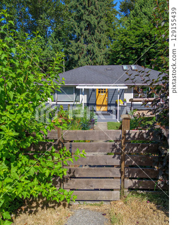 Perfect neighbourhood. Main entrance of family residential house with decorative flowers Perfect neighbourhood. Main entrance of family residential house with decorative flowers 129155439