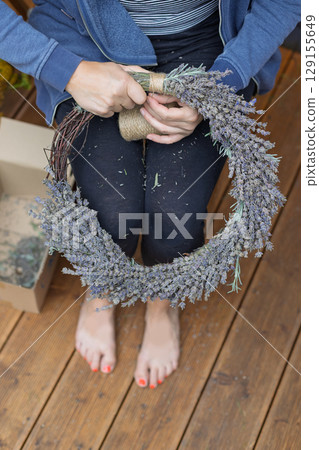Barefoot Woman Finishing Lavender Wreath by Hand 129155649