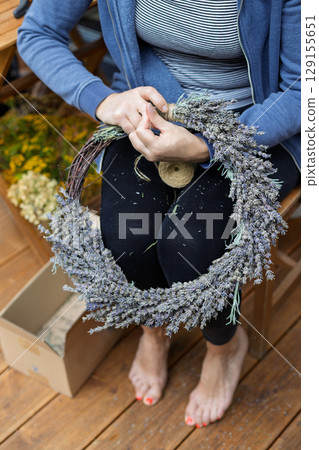 Barefoot Woman Working on Lavender Wreath 129155651