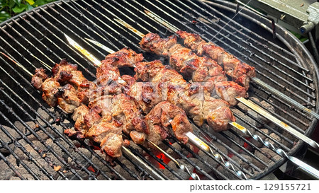 Pieces of meat on a skewer grilled 129155721