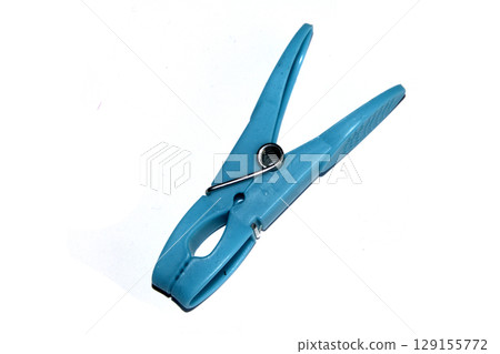 Colourful vibrant clothes pegs on a white background close up for laundry day 129155772