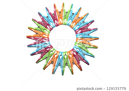 Colourful vibrant clothes pegs on a white background close up for laundry day Colourful vibrant clothes pegs on a white background close up for laundry day 129155779