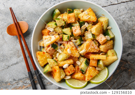 Rojak is a mixed salad combining tropical fruits, vegetables and tofu tossed in a thick dressing closeup in the bowl. Horizontal top view Rojak is a mixed salad combining tropical fruits, vegetables and tofu tossed in a thick dressing closeup in the bowl. Horizontal top view 129156810