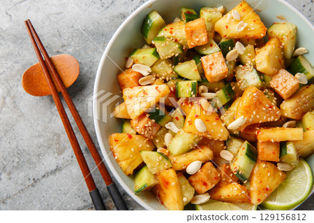 Rujak or rojak is a salad dish of a mixture of sliced fruit and vegetables and served with a spicy palm sugar dressing closeup in the bowl. Horizontal top view Rujak or rojak is a salad dish of a mixture of sliced fruit and vegetables and served with a spicy palm sugar dressing closeup in the bowl. Horizontal top view 129156812