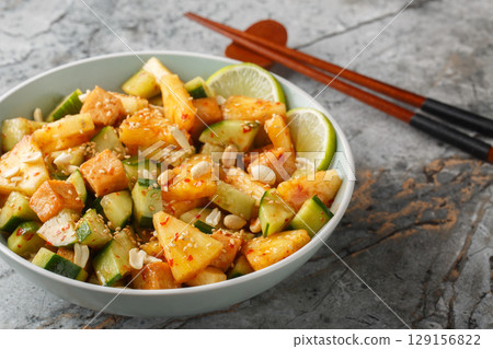 Rujak or rojak is a salad dish of a mixture of sliced fruit and vegetables and served with a spicy palm sugar dressing closeup in the bowl. Horizontal Rujak or rojak is a salad dish of a mixture of sliced fruit and vegetables and served with a spicy palm sugar dressing closeup in the bowl. Horizontal 129156822