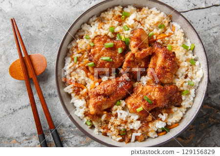 Tori meshi Japanese tradition food chicken and rice closeup in the bowl. Horizontal top view Tori meshi Japanese tradition food chicken and rice closeup in the bowl. Horizontal top view 129156829
