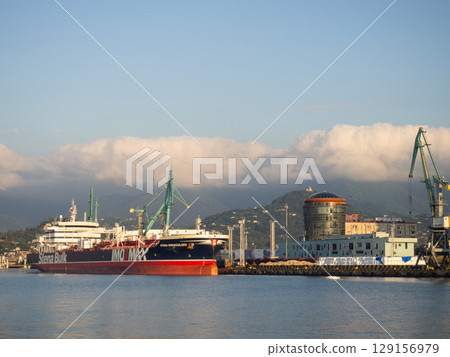 Landscape in the seaport. Port in the Caucasus. Ships and mountains. Clouds over the mountains. Port in Batumi. Logistics. Black Sea cargo transportation industry 129156979