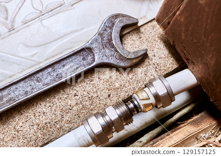 Compression fitting insert is positioned in front of multilayer pipe opening, once inserted, compression nut will tighten clamping ring. 129157125