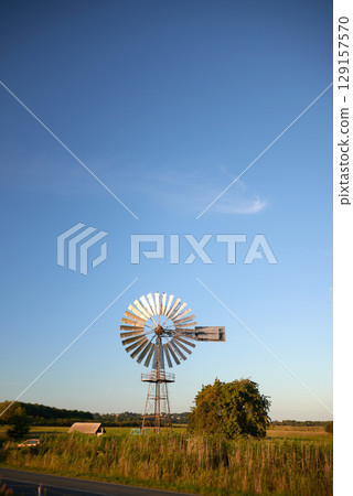 windmill used for regulationof water flow in agriculture as water pump 129157570