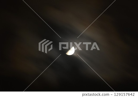 half moon covering by cloud floating on sky in night background half moon covering by cloud floating on sky in night background 129157642