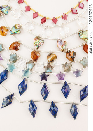 Collection of natural stone beads cut into heart, star, and diamond shapes | Jewelry material image 129157648