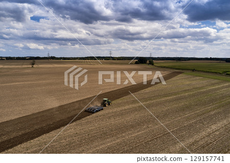 plowing farm after harvesting with vehicle plowing farm after harvesting with vehicle 129157741