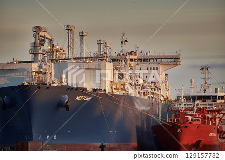 Lubmin, Germany - 01 28 2023: First LNG terminal with LNG tanker Neptune (Offshore Support Vessel, IMO 9385673) moored for regasification of LNG from LNG tanker Coral Furcata in the evening 129157782