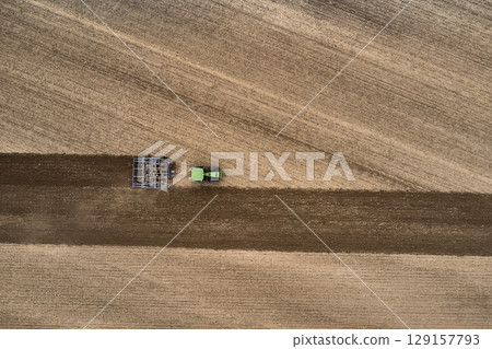 plowing farm after harvesting with vehicle plowing farm after harvesting with vehicle 129157793