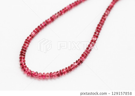 High-quality red spinel beads | Close-up photo of a translucent red natural stone 129157858
