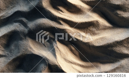 Close-up view of natural sand texture, showing intricate ripples, light, and shadow patterns. Seamless tile. 129160816