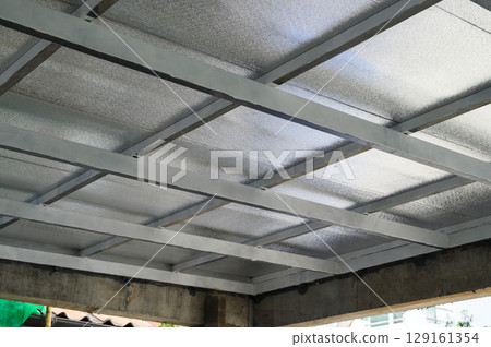 Gray metal beams form robust framework supporting large sheet panels possibly incorporating pu foam for insulation common building material structure construction 129161354