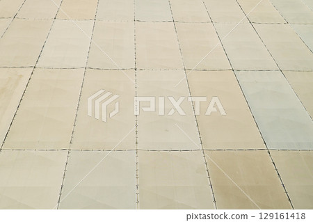 Close-up of fire-retardant mesh sheets covering a building under construction Close-up of fire-retardant mesh sheets covering a building under construction 129161418