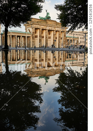 Famous Brandenburger Tor mirroring in a puddle 129161656