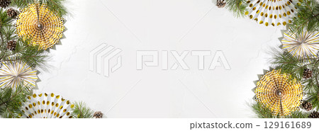Winter holidays background. Christmas and New banner with fir branches, cones and holiday paper decoration on a white background with copy space. Flat lay, banner size 129161689