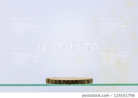 Wooden empty podium on a glass shelf on a blue background. Round show case for natural cosmetic products. Concept scene stage for new product, promotion sale and presentation. Front view Wooden empty podium on a glass shelf on a blue background. Round show case for natural cosmetic products. Concept scene stage for new product, promotion sale and presentation. Front view 129161706