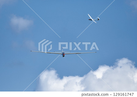 Glider in the sky begin landing Glider in the sky begin landing 129161747