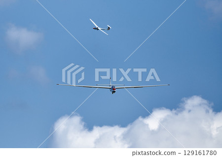 Glider in the sky begin landing Glider in the sky begin landing 129161780