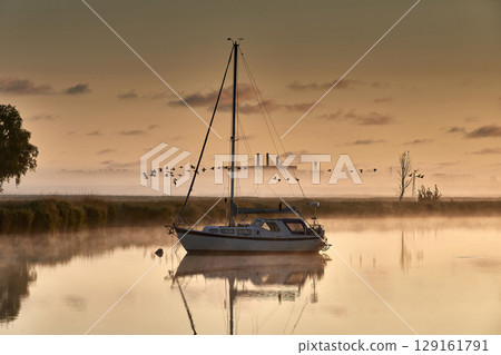boat scenery on a foggy morning at baltic sea boat scenery on a foggy morning at baltic sea 129161791