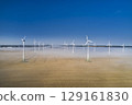 onshore wind turbine standing in fog in the morning sun 129161830