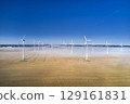onshore wind turbine standing in fog in the morning sun 129161831