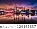 Harbor Evening with Moored Sailboats and Overcast Sky in the Evening Light 129161837