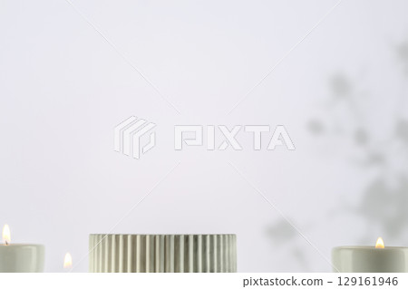 Marble podium with candles on a light gradient background with shadows. Concept scene stage showcase for new product, promotion sale, banner, presentation, cosmetic. Soft image and soft focus style Marble podium with candles on a light gradient background with shadows. Concept scene stage showcase for new product, promotion sale, banner, presentation, cosmetic. Soft image and soft focus style 129161946