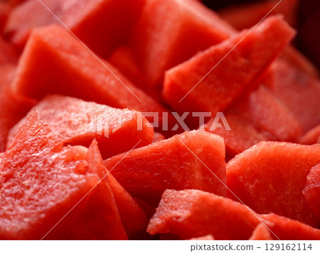Close-up of juicy watermelon slices with vibrant red color and textured surface. 129162114