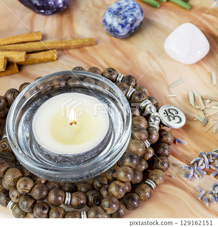 Self-care, healing composition with rosary beads, chakra stones, sandalwood sticks and candle on a pink marble podium. Concept of relaxing at home, energy healing, yoga, meditation and me time Self-care, healing composition with rosary beads, chakra stones, sandalwood sticks and candle on a pink marble podium. Concept of relaxing at home, energy healing, yoga, meditation and me time 129162151
