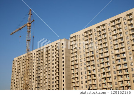 A Modern Apartment Building is Currently Under Construction in an Urban Environment 129162186