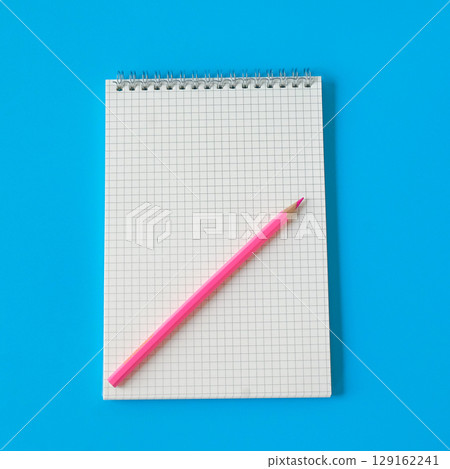 Top view of notebook and color pencil on background. 129162241