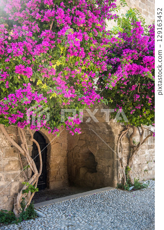 Ancient buildings with flowers on Rhodes island, Greece Ancient buildings with flowers on Rhodes island, Greece 129163452